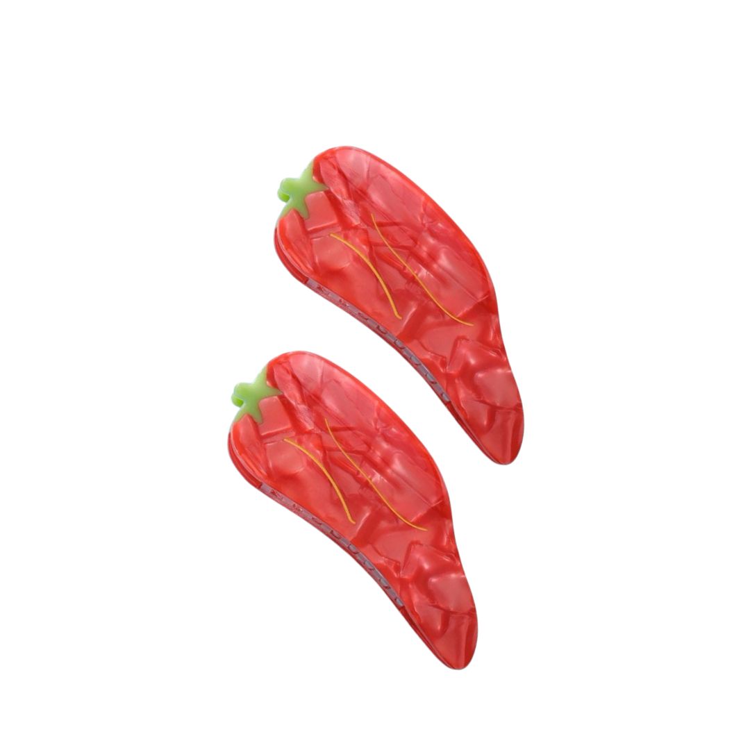 A set of two red hair claws designed to resemble hot tamales, with visible details mimicking the texture and color of a tamale.