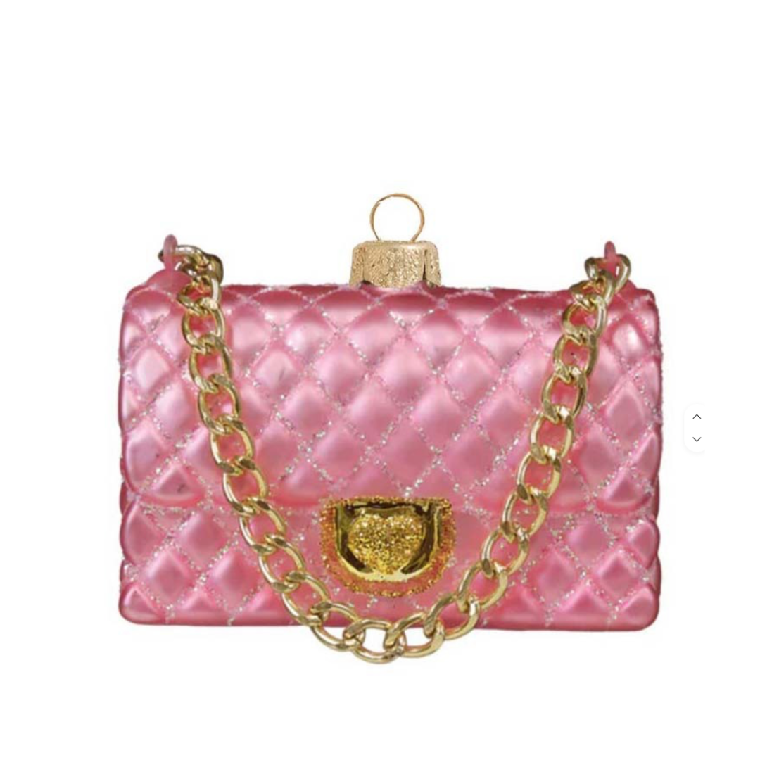 A pink quilted shoulder bag with a gold-tone chain strap and gold clasp, shown on a plain white background.