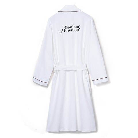 White robe that reads in black text "Bonjour Monsieur"
